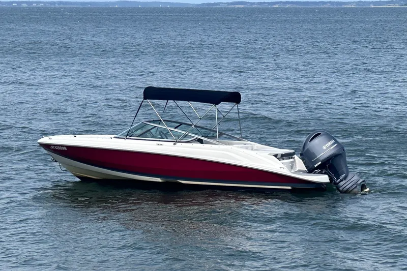 Slide: The Image of 2020 Regal 21 OBX boat with Yamaha outboard motor on open water. - 1