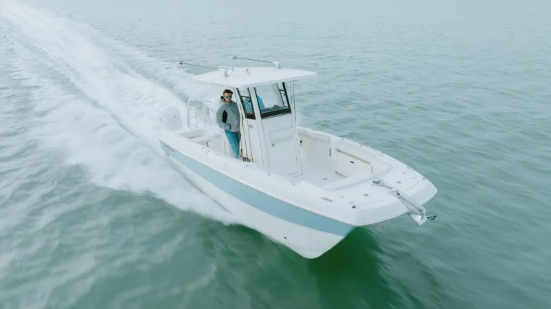 Slide: The Image of 2026 World Cat 235TE boat cruising on open water, showcasing sleek design and performance. - 4