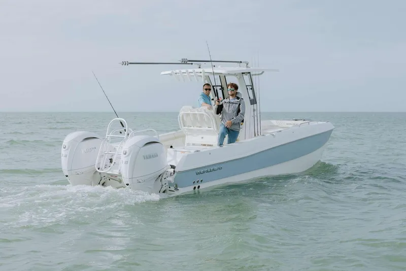 Slide: The Image of 2026 World Cat 235TE boat cruising on open water with two people onboard. - 19