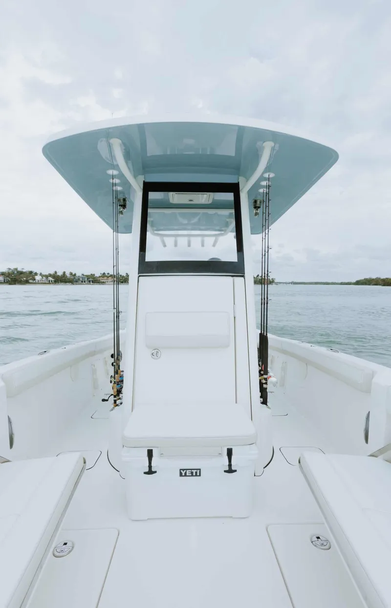 Slide: The Image of 2026 World Cat 235TE boat on water, featuring sleek design and spacious deck. - 38