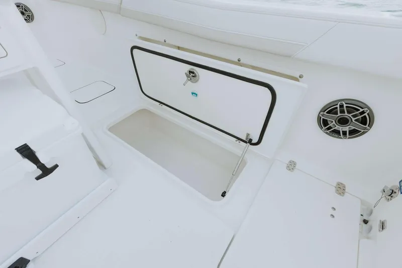 Slide: The Image of 2026 World Cat 235TE boat interior with storage compartment and speaker. - 47