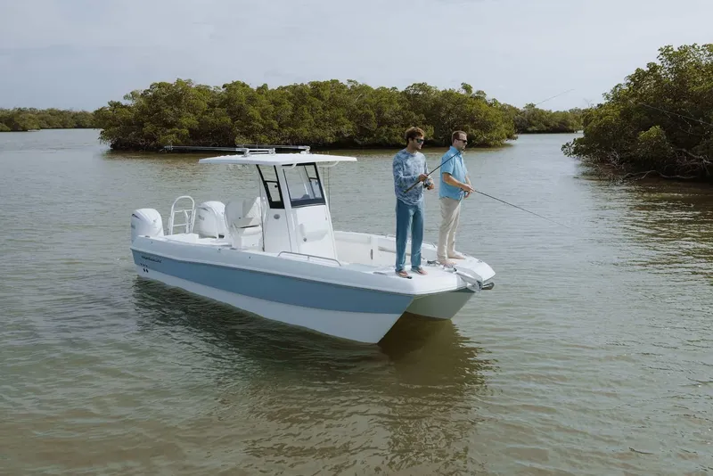 Slide: The Image of Two people fishing on a 2026 World Cat 235TE boat in calm waters. - 22