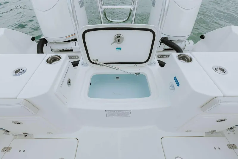 Slide: The Image of 2026 World Cat 235TE boat with open storage compartment on deck. - 46
