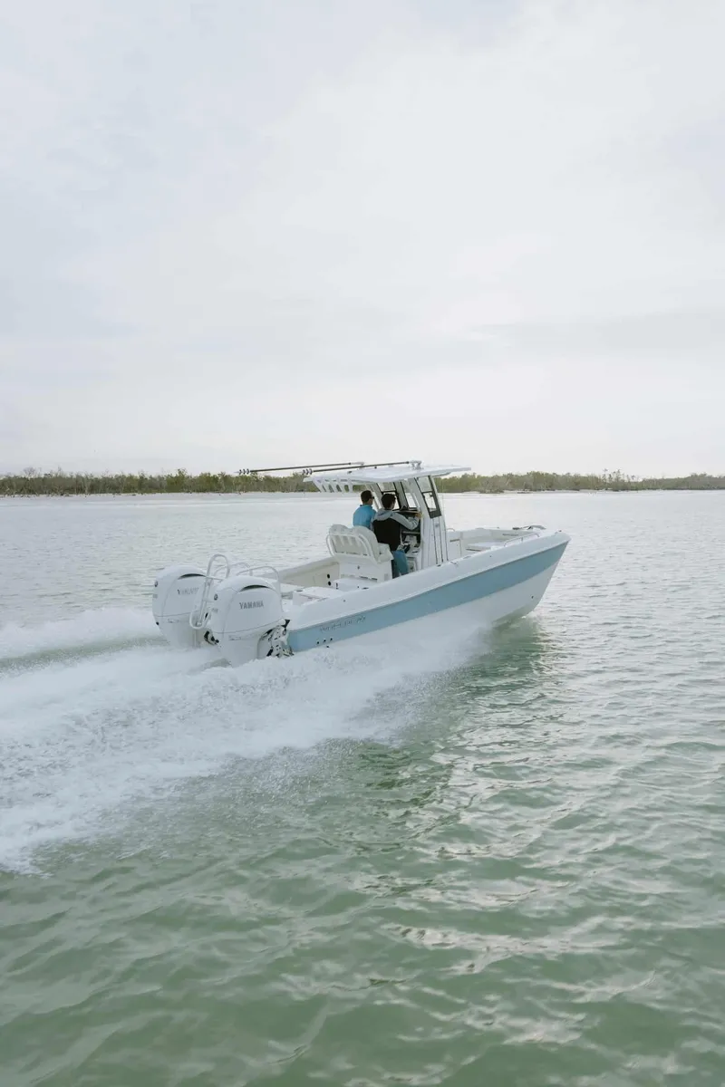 Slide: The Image of 2026 World Cat 235TE boat cruising on open water. - 11