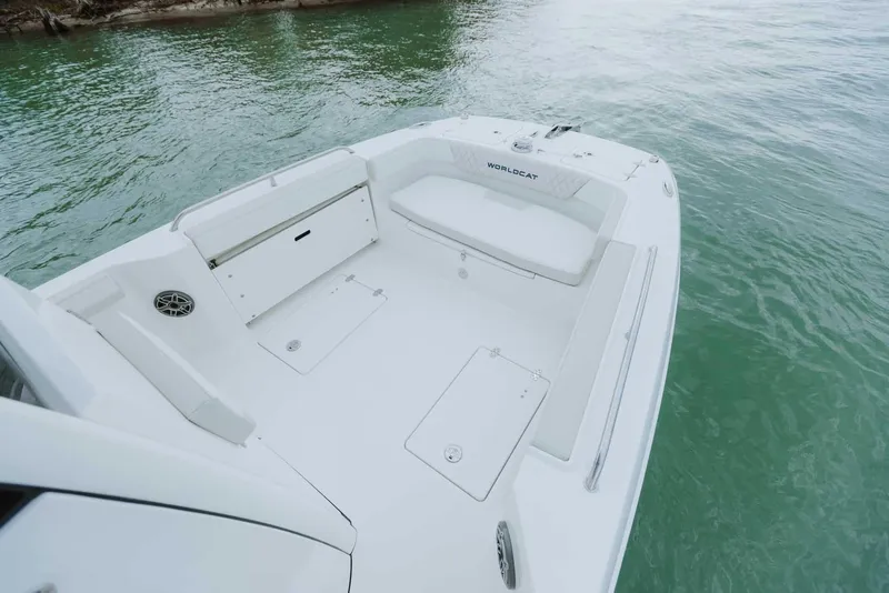 Slide: The Image of 2026 World Cat 235TE boat deck with seating, on calm water. - 30