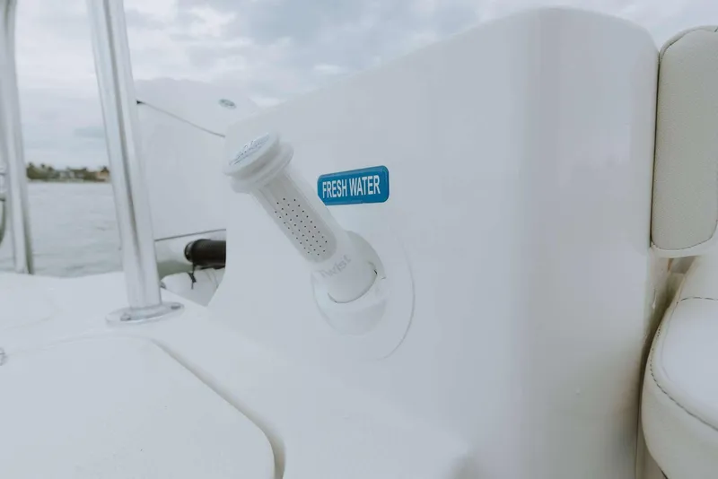 Slide: The Image of Freshwater outlet on 2026 World Cat 235TE boat, featuring sleek white design. - 39