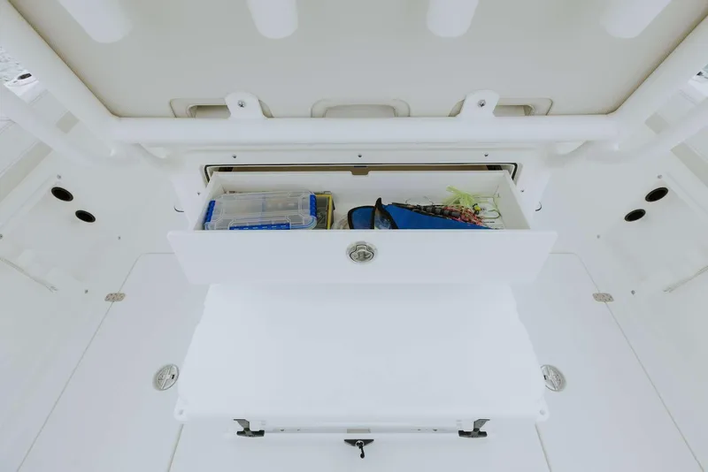 Slide: The Image of 2026 World Cat 235TE boat storage compartment with fishing gear and accessories. - 34