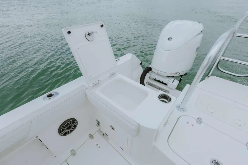 Slide: The Image of 2026 World Cat 235TE boat with open storage compartment and outboard motor on water. - 43