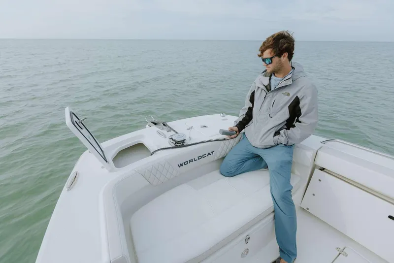 Slide: The Image of Man relaxing on a 2026 World Cat 235TE boat, enjoying the ocean view. - 16