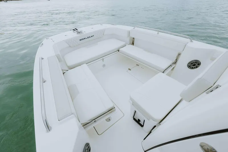 Slide: The Image of 2026 World Cat 235TE boat interior with spacious seating on calm water. - 37