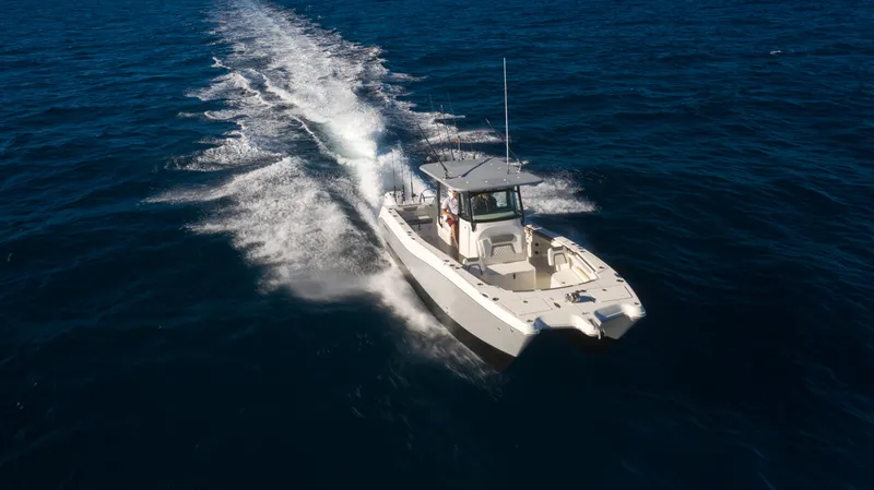 Slide: The Image of 2026 World Cat 325CC cruising on open ocean waters. - 6