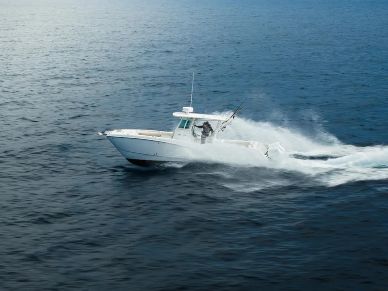 Slide: The Image of 2026 World Cat 325CC cruising swiftly on open water. - 5