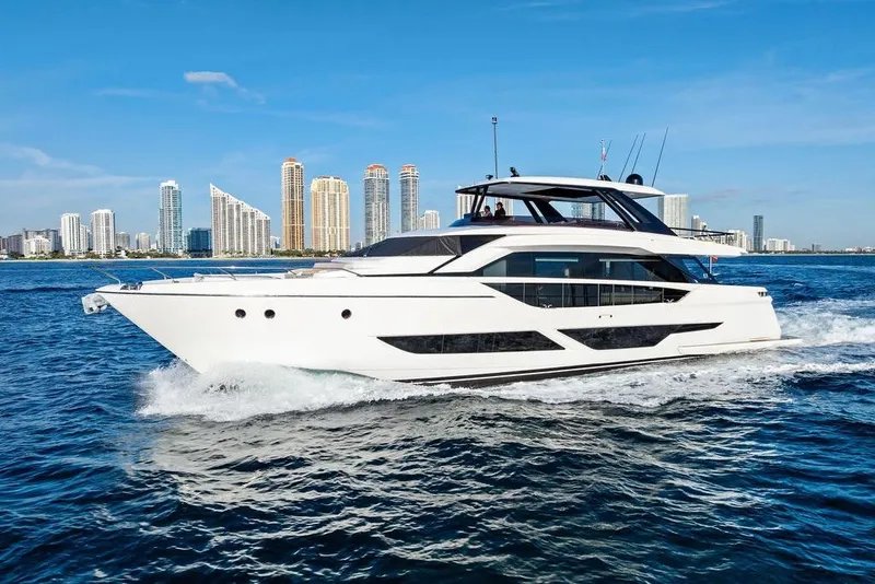 Slide: The Image of 2023 Ferretti Yachts 860 cruising near city skyline on a sunny day. - 1