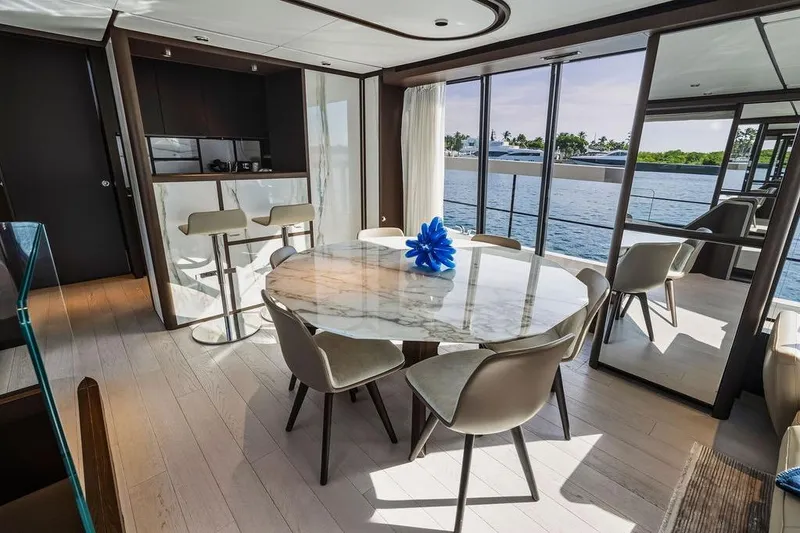 Slide: The Image of Luxurious 2023 Ferretti Yachts 860 interior with elegant dining area and scenic ocean view. - 14