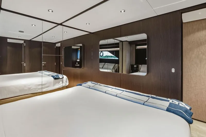 Slide: The Image of Luxurious bedroom interior of 2023 Ferretti Yachts 860, featuring elegant wood paneling and modern design. - 51