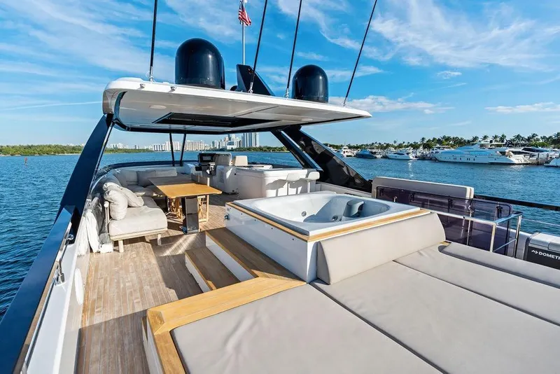 Slide: The Image of Luxurious 2023 Ferretti Yachts 860 with spacious deck and jacuzzi, docked in scenic marina. - 29