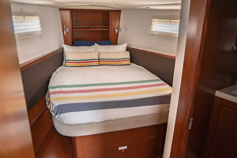 Slide: The Image of Cozy cabin interior of 2015 Bavaria Vision 46 yacht with striped bedding. - 27