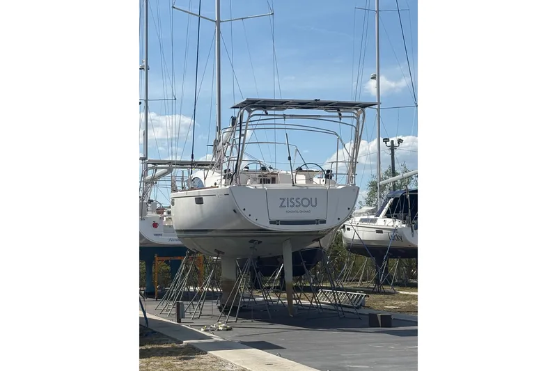Slide: The Image of Sailboat Bavaria Vision 46, 2015 model, named "Zissou," docked on land in a marina. - 40