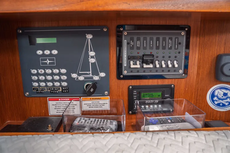 Slide: The Image of Control panel of a 2015 Bavaria Vision 46 yacht with electrical switches and warnings. - 25