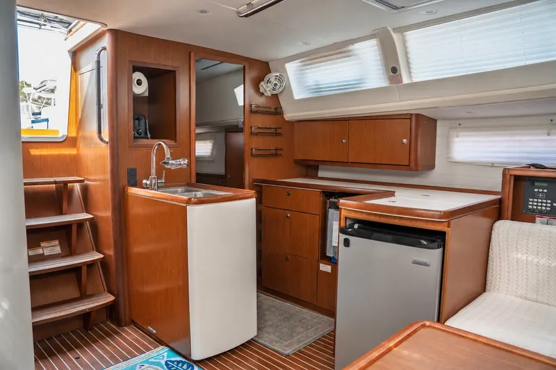Slide: The Image of Interior of 2015 Bavaria Vision 46 yacht with modern kitchen and wooden cabinetry. - 20