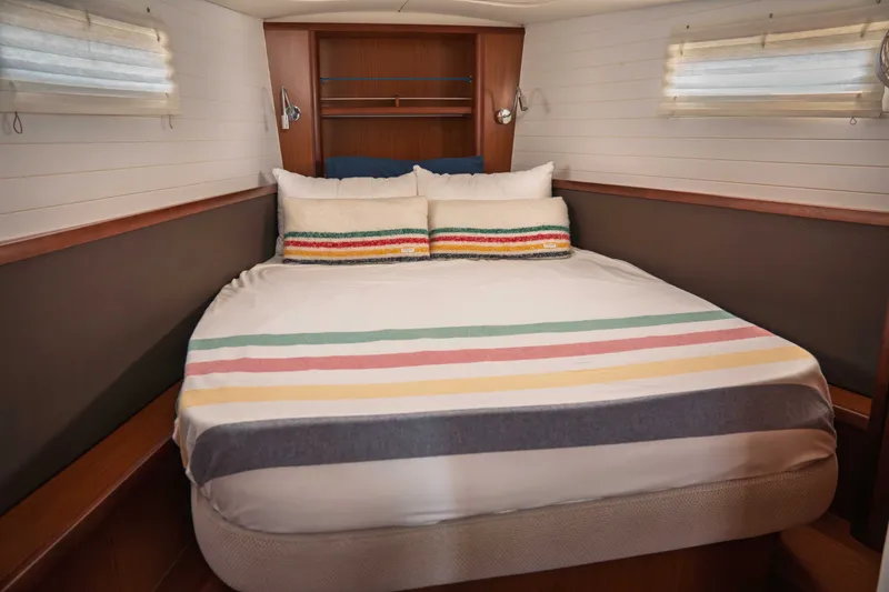 Slide: The Image of Cozy cabin interior of 2015 Bavaria Vision 46 yacht with striped bedding. - 26