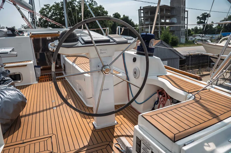 Slide: The Image of Cockpit of 2015 Bavaria Vision 46 sailboat with wooden deck and steering wheel. - 13