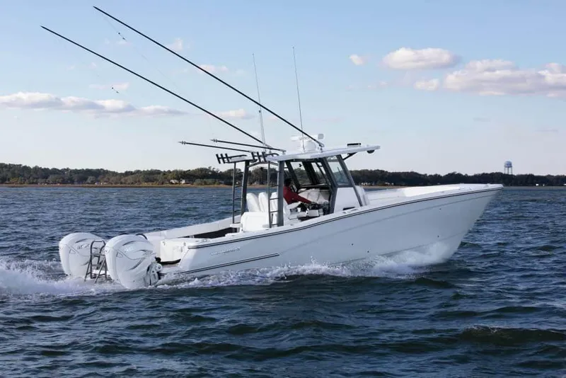 The Image of 2026 World Cat 400CC-X boat cruising on open water under a clear sky. - 0