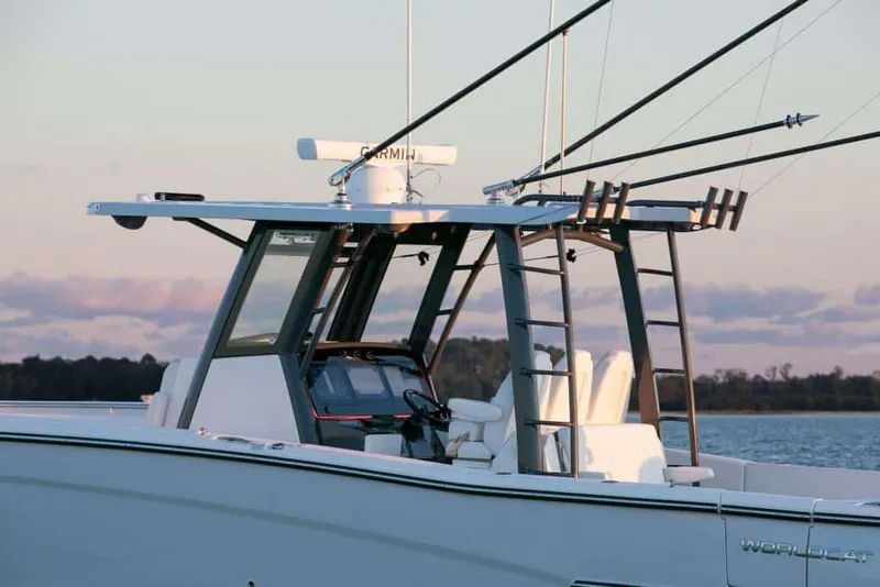 Slide: The Image of 2026 World Cat 400CC-X boat with fishing rods, sleek design, and modern features on calm water. - 8