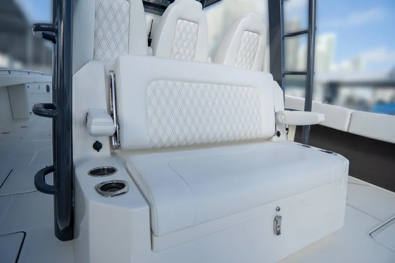 Slide: The Image of 2026 World Cat 400CC-X boat interior with white cushioned seating and cup holders. - 14