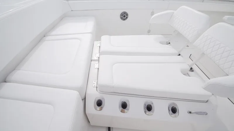 Slide: The Image of Luxury seating on 2026 World Cat 400CC-X boat, featuring white cushioned seats and rod holders. - 48