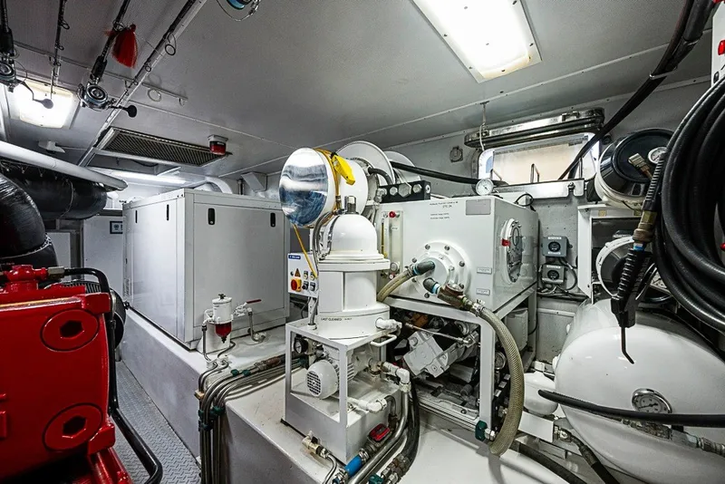 Slide: The Image of Engine room of 1997 Delta Marine Tri-deck Motoryacht, showcasing machinery and equipment. - 86