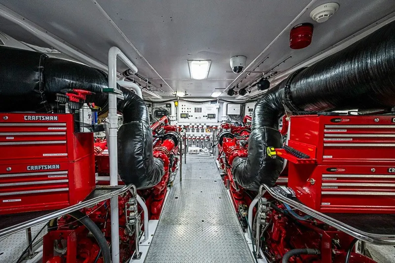 Slide: The Image of Engine room of 1997 Delta Marine Tri-deck Motoryacht with red Craftsman toolboxes and machinery. - 83
