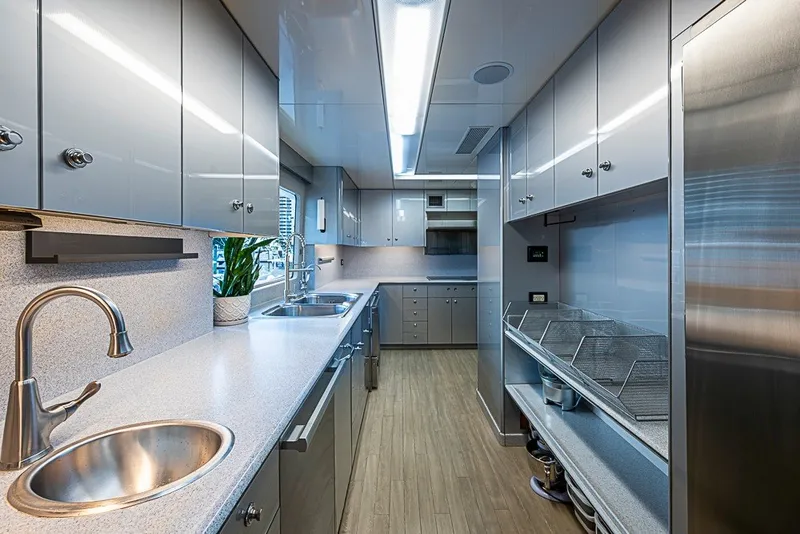 Slide: The Image of Luxurious yacht kitchen with modern appliances, sleek cabinetry, and ample counter space on a Delta Marine Tri-deck. - 15