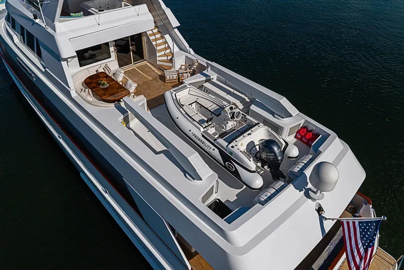 Slide: The Image of Luxurious 1997 Delta Marine Tri-deck Motoryacht with spacious deck and tender, cruising on calm waters. - 93