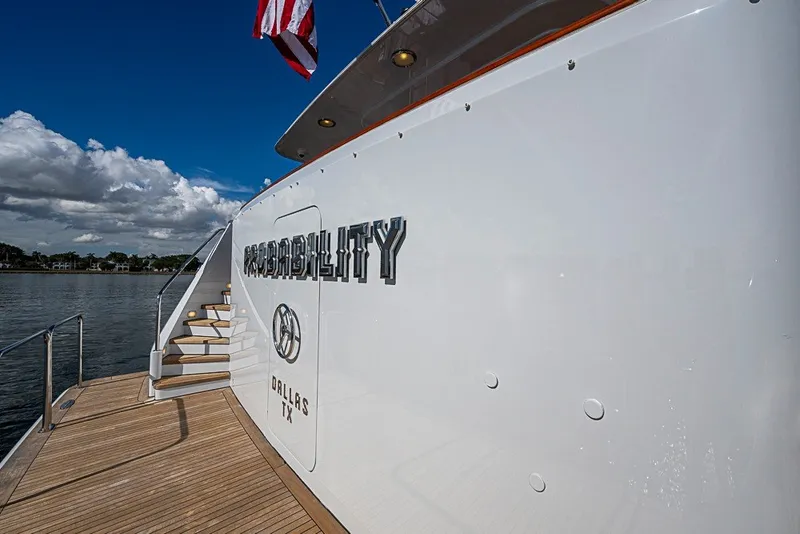 Slide: The Image of Luxury Delta Marine Tri-deck Motoryacht, 1997, docked with elegant wooden deck and stairs. - 82