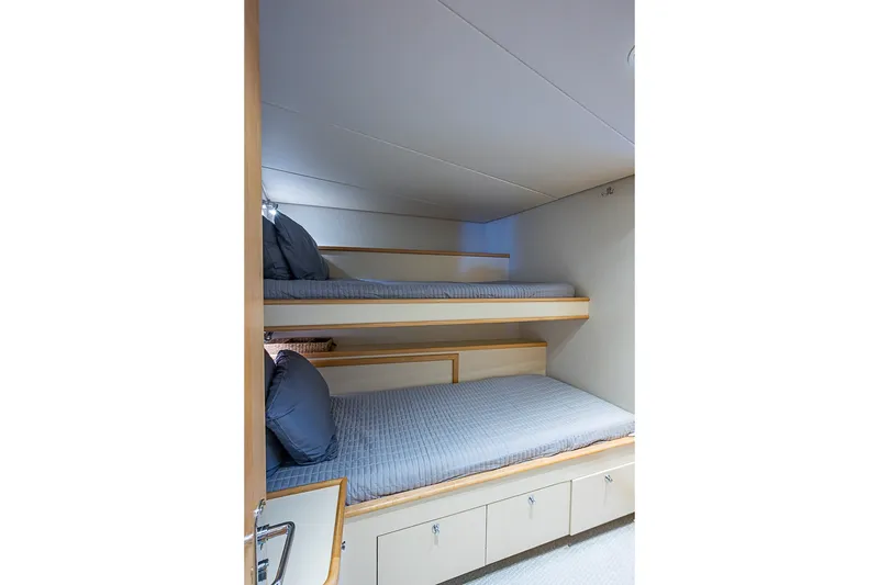 Slide: The Image of Bunk beds in 1997 Delta Marine Tri-deck Motoryacht cabin, featuring modern design and storage. - 55
