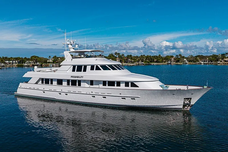 The Image of Luxurious 1997 Delta Marine Tri-deck Motoryacht cruising on serene waters under a clear blue sky. - 0