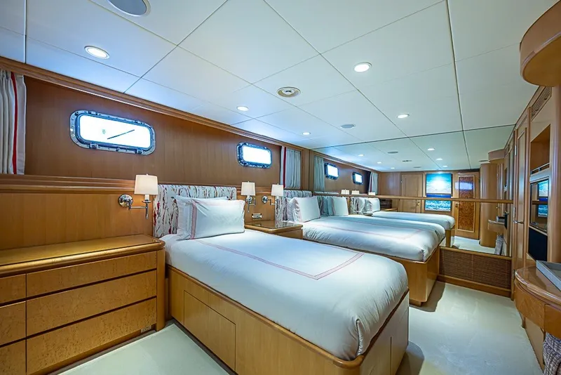 Slide: The Image of Luxurious bedroom on 1997 Delta Marine Tri-deck Motoryacht with twin beds and elegant wood paneling. - 44