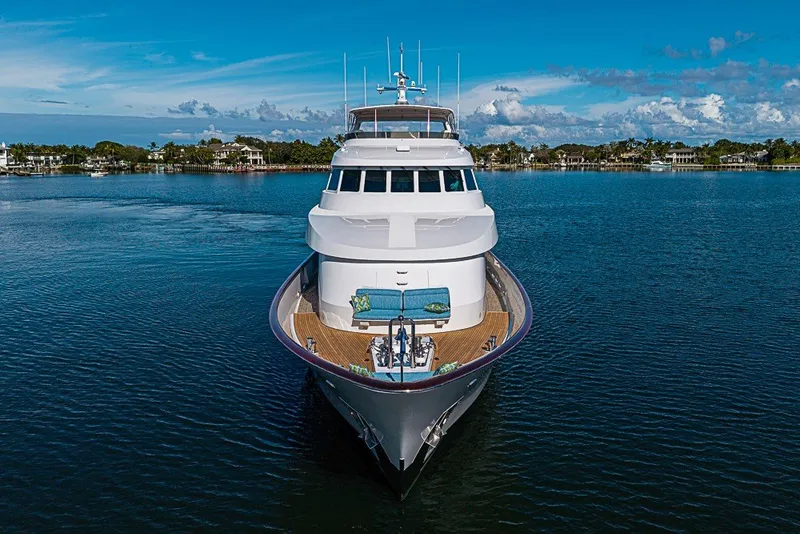 Slide: The Image of 1997 Delta Marine Tri-deck Motoryacht on serene water with clear blue sky. - 97