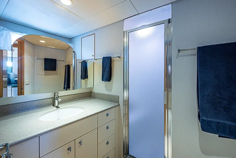Slide: The Image of Luxurious bathroom on 1997 Delta Marine Tri-deck Motoryacht with modern fixtures and frosted glass shower. - 58