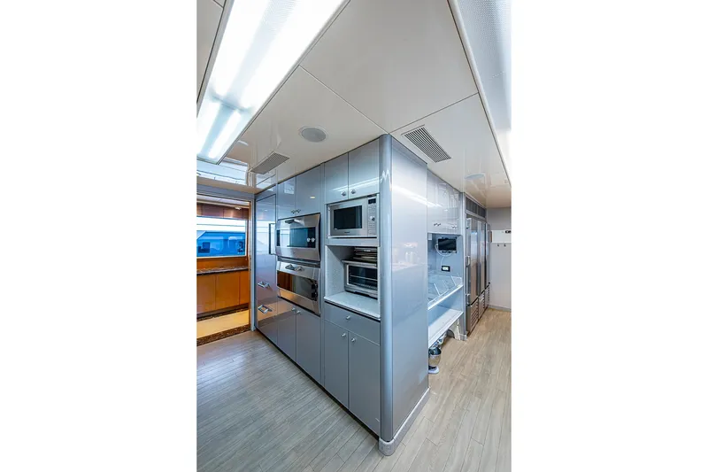 Slide: The Image of Modern kitchen interior on 1997 Delta Marine Tri-deck Motoryacht, featuring sleek cabinetry and appliances. - 18
