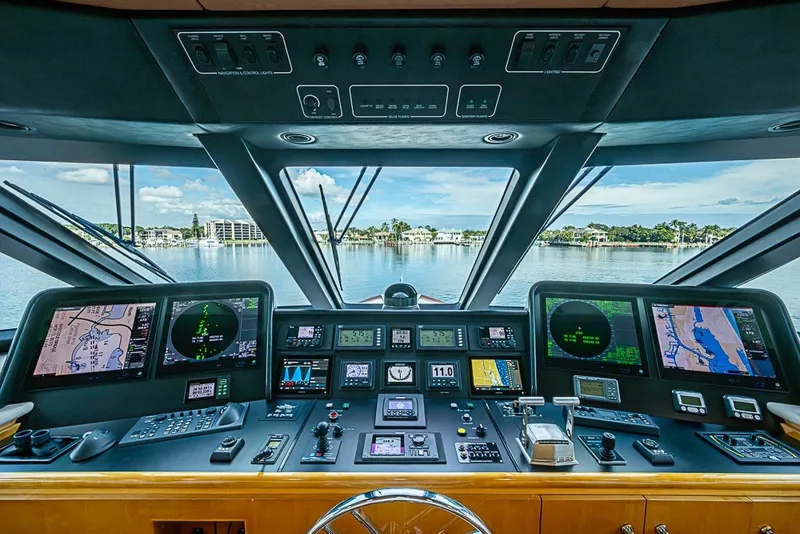 Slide: The Image of Bridge of 1997 Delta Marine Tri-deck Motoryacht with navigation screens and controls. - 29
