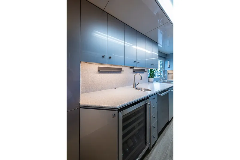Slide: The Image of Luxurious kitchen interior on a 1997 Delta Marine Tri-deck Motoryacht, featuring sleek cabinetry and modern appliances. - 17