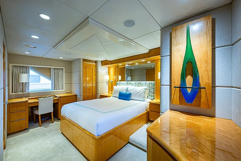 Slide: The Image of Luxurious bedroom interior on a 1997 Delta Marine Tri-deck Motoryacht, featuring elegant wood finishes. - 40