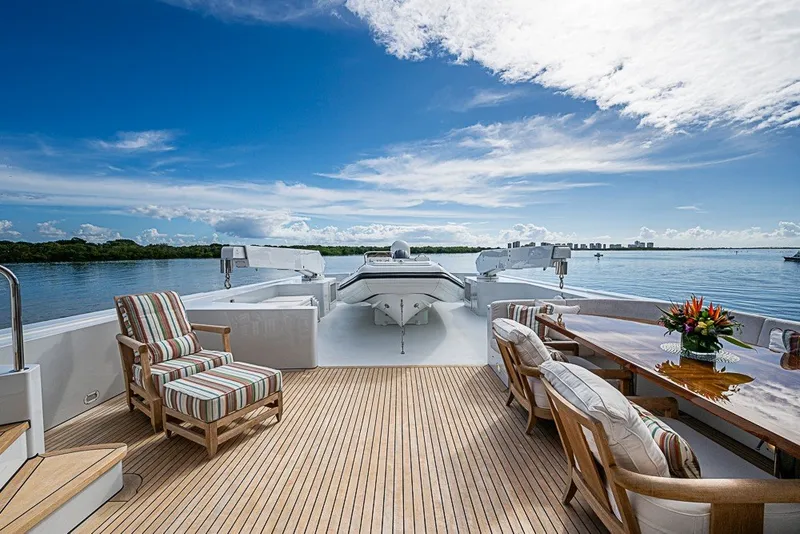 Slide: The Image of Luxurious 1997 Delta Marine Tri-deck Motoryacht deck with seating, table, and scenic water view. - 69