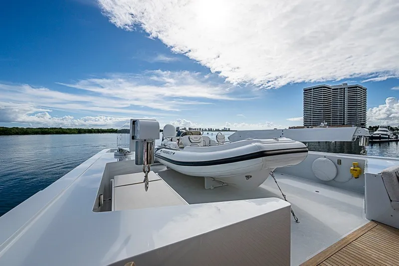 Slide: The Image of Luxurious 1997 Delta Marine Tri-deck Motoryacht with tender on deck, under a bright sky. - 70