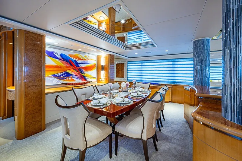 Slide: The Image of Luxurious dining area on 1997 Delta Marine Tri-deck Motoryacht with elegant decor and vibrant artwork. - 9