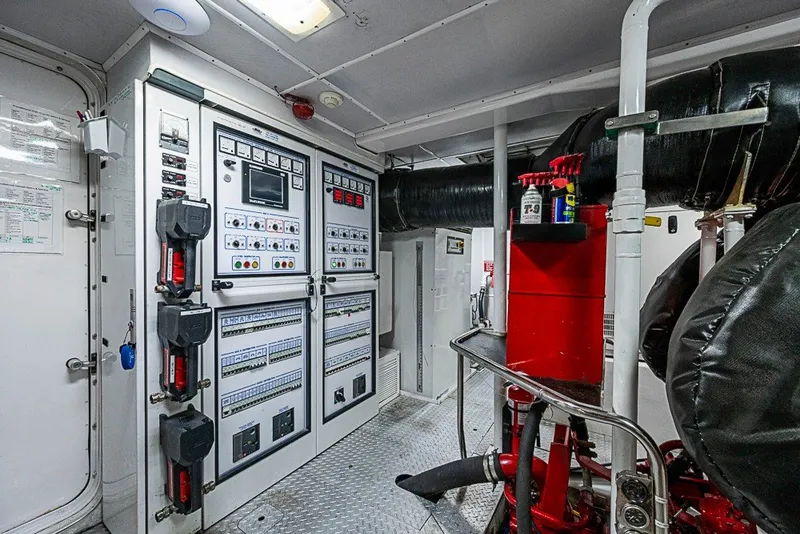 Slide: The Image of Engine room of a 1997 Delta Marine Tri-deck Motoryacht with control panels and equipment. - 84
