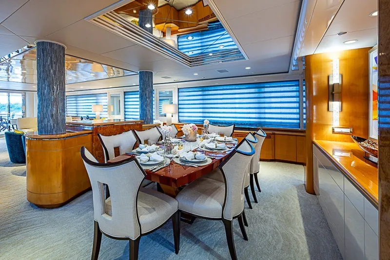 Slide: The Image of Luxurious dining area on a 1997 Delta Marine Tri-deck Motoryacht, featuring elegant decor and seating. - 11