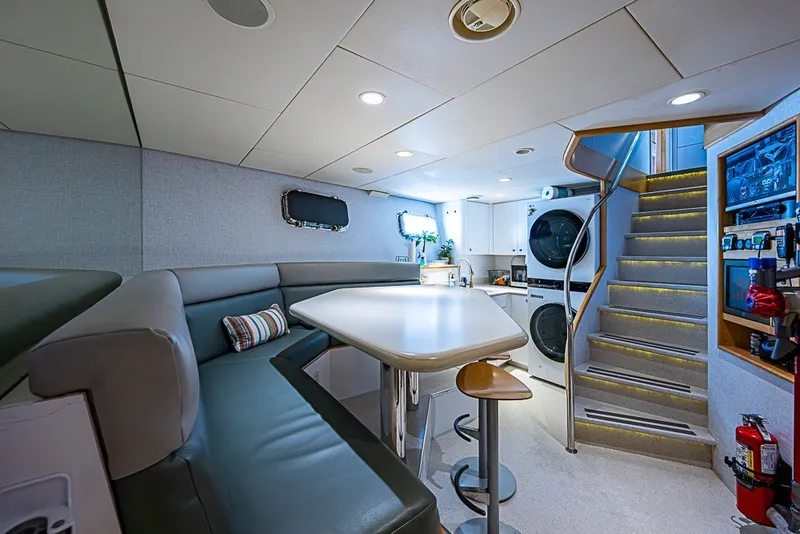 Slide: The Image of Luxurious 1997 Delta Marine Tri-deck Motoryacht interior with modern seating, laundry, and staircase. - 59